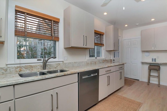 44 Commercial St, Provincetown, MA 02657 - kitchen with dishwasher, a sink, light wood-style floors, recessed lighting, and light stone counters