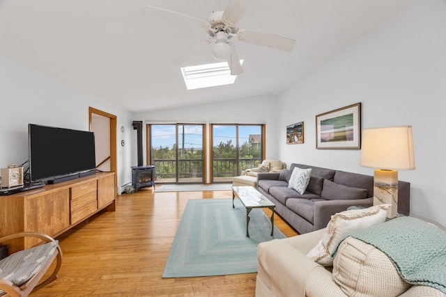 5 Great Hills Rd, Truro, MA 02666 - living room featuring a skylight, vaulted ceiling, ceiling fan, light wood-style floors, and a wood stove