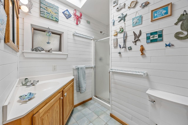 5 Great Hills Rd, Truro, MA 02666 - bathroom with vanity, tile patterned flooring, a stall shower, wooden walls, and a skylight