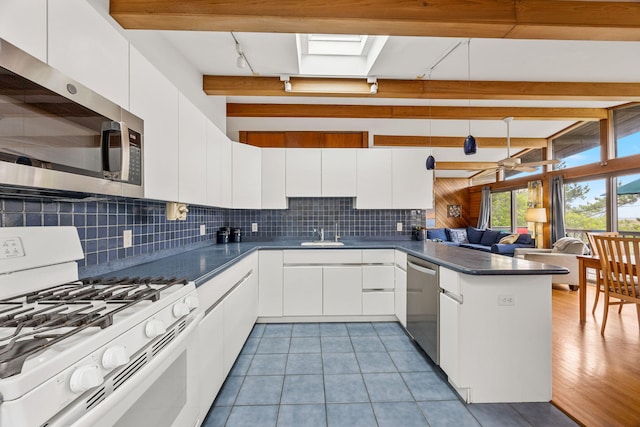 5 Great Hills Rd, Truro, MA 02666 - kitchen featuring stainless steel appliances, dark countertops, a peninsula, white cabinetry, and beamed ceiling