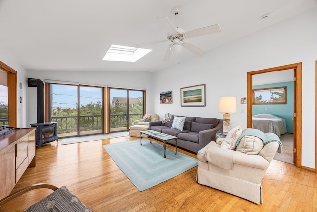 5 Great Hills Rd, Truro, MA 02666 - living area with lofted ceiling, a wood stove, a skylight, light wood-type flooring, and ceiling fan