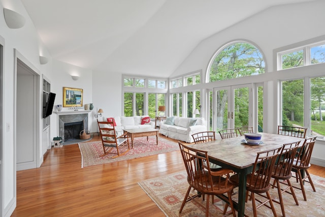 20 James Pond Way, West Tisbury, MA 02575 - dining space featuring light wood finished floors, a high end fireplace, and high vaulted ceiling