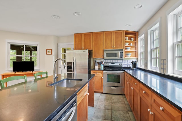 20 James Pond Way, West Tisbury, MA 02575 - kitchen featuring stainless steel appliances, a sink, brown cabinets, tasteful backsplash, and recessed lighting