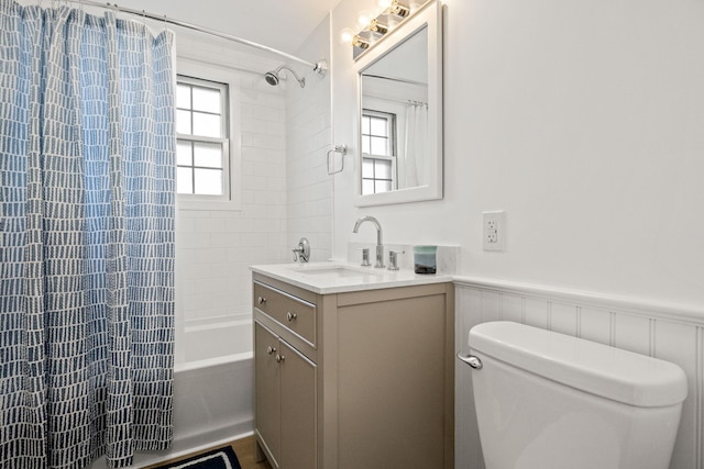 full bathroom with shower / bath combo with shower curtain, toilet, and vanity