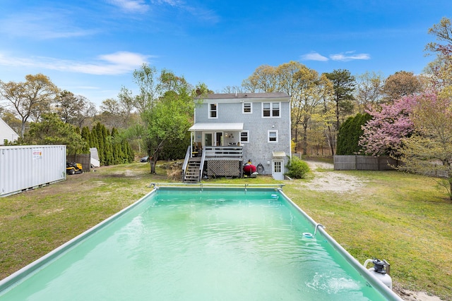 239 Upper County Rd, South Dennis, MA 02660 - rear view of house featuring a deck, stairway, an outdoor pool, and view of wooded area