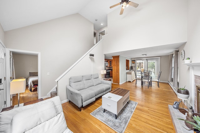 239 Upper County Rd, South Dennis, MA 02660 - living area with stairs, high vaulted ceiling, ceiling fan, and light wood-type flooring