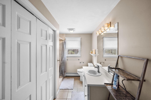 239 Upper County Rd, South Dennis, MA 02660 - full bath featuring a baseboard heating unit, toilet, tile patterned floors, vanity, and a closet