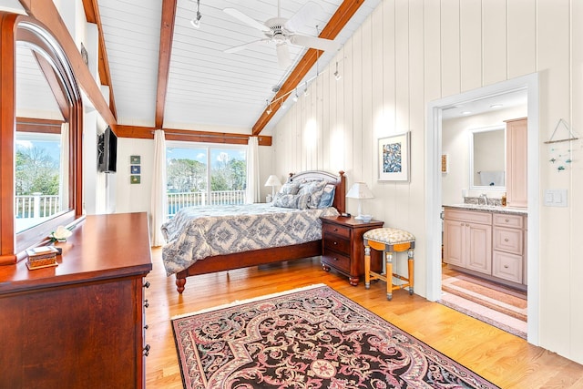 bedroom with access to outside, ceiling fan, a sink, vaulted ceiling with beams, and light wood-type flooring