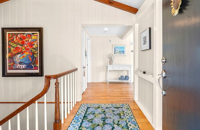 hall featuring vaulted ceiling and light wood finished floors