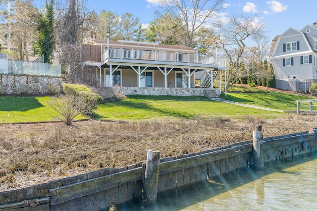 rear view of property with a yard, a wooden deck, and stairs
