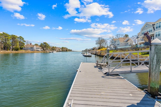 dock area with a water view and a residential view