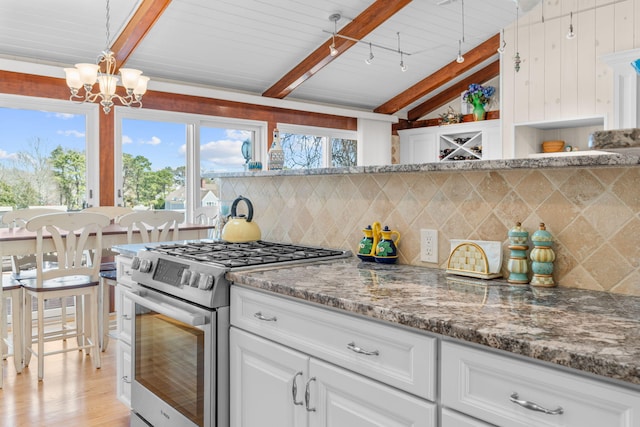 kitchen featuring open shelves, stainless steel range with gas cooktop, vaulted ceiling with beams, tasteful backsplash, and a notable chandelier