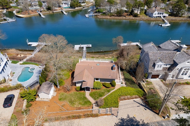 drone / aerial view featuring a residential view and a water view