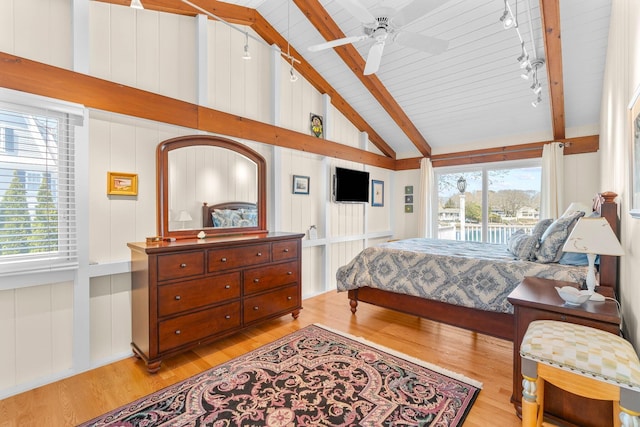bedroom featuring light wood-style floors, access to outside, and multiple windows