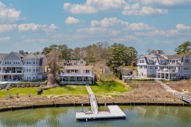 exterior space with a deck with water view and a yard