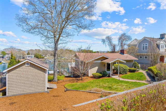 exterior space with fence, a front lawn, and a residential view