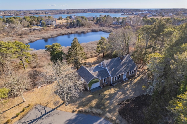 drone / aerial view featuring a water view and a forest view