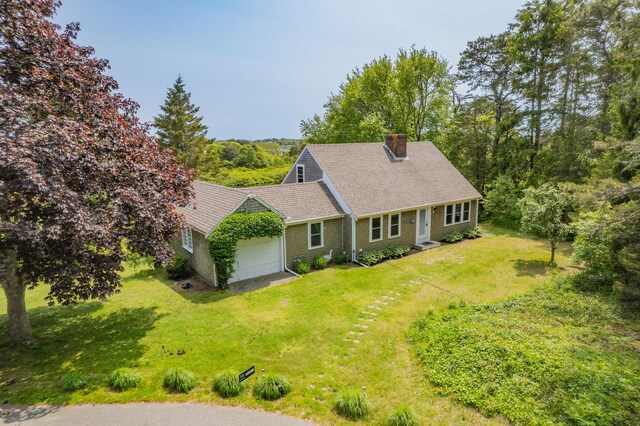 9 Bettys Path, Chatham, MA 02633 - view of front of house featuring a garage, driveway, a chimney, roof with shingles, and a front lawn