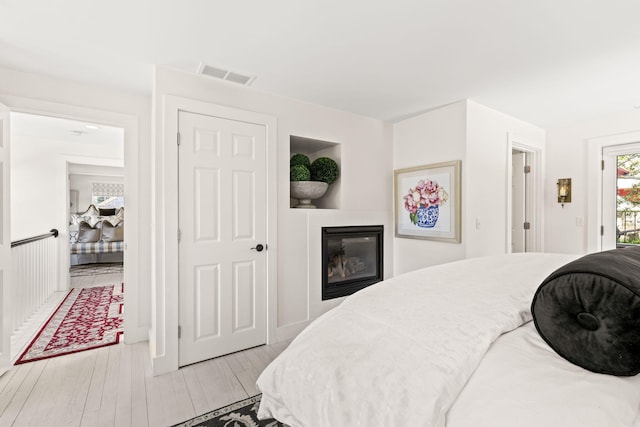 15 Sylvan Way S, Chatham, MA 02659 - bedroom featuring light wood-style flooring and a tile fireplace