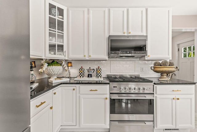 15 Sylvan Way S, Chatham, MA 02659 - kitchen featuring stainless steel appliances, white cabinetry, decorative backsplash, dark stone countertops, and glass insert cabinets