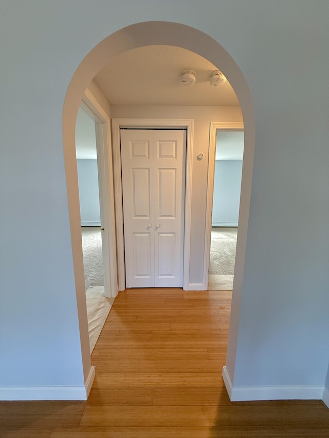 56 Center St Unit 2-3, Dennis Port, MA 02639 - hall with arched walkways, light wood-style flooring, and baseboards