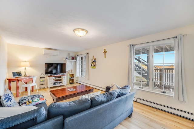 living room featuring a baseboard heating unit, a wall mounted air conditioner, light wood finished floors, and baseboard heating