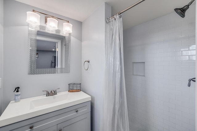 bathroom featuring vanity and a shower stall