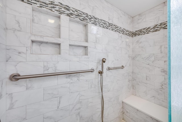 bathroom featuring a tile shower