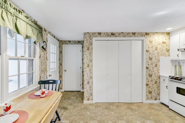 33 Swift Brook Rd, South Yarmouth, MA 02664 - kitchen with white cabinetry, white range oven, and ventilation hood