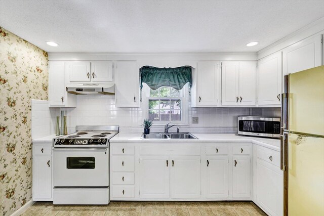 33 Swift Brook Rd, South Yarmouth, MA 02664 - kitchen featuring white cabinetry, tasteful backsplash, white range with electric cooktop, sink, and fridge