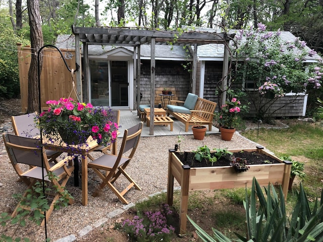 view of patio with a wooden deck, a pergola, and an outdoor living space