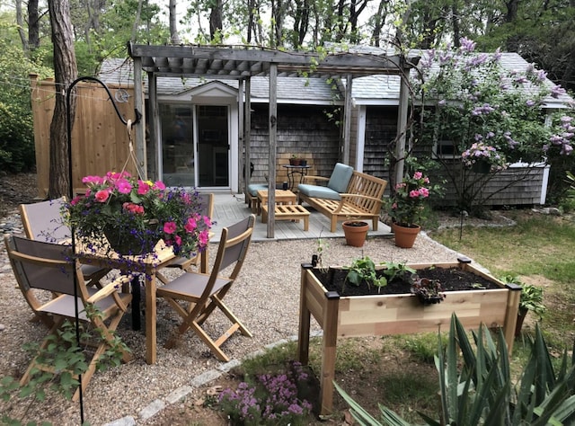 view of patio featuring a pergola, outdoor lounge area, and a wooden deck
