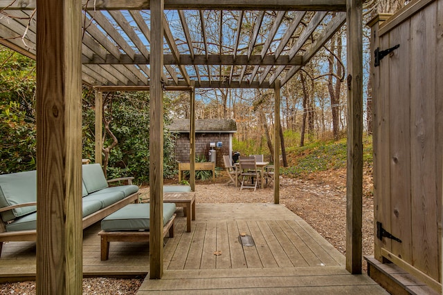 wooden deck with a pergola, an outdoor living space, an outdoor structure, and a storage unit