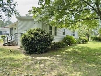 37 Washington Park, Carver, MA 02330 - view of side of home featuring a yard and entry steps