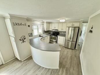 37 Washington Park, Carver, MA 02330 - kitchen featuring light wood finished floors, appliances with stainless steel finishes, a peninsula, and white cabinetry