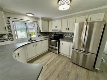 37 Washington Park, Carver, MA 02330 - kitchen featuring appliances with stainless steel finishes, white cabinetry, tasteful backsplash, light wood-style floors, and crown molding