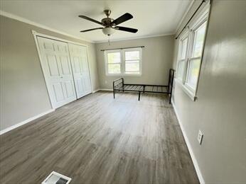 37 Washington Park, Carver, MA 02330 - unfurnished bedroom with crown molding, wood finished floors, a closet, and ceiling fan