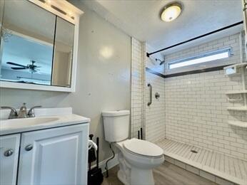 37 Washington Park, Carver, MA 02330 - full bathroom featuring vanity, a tile shower, and wood finished floors