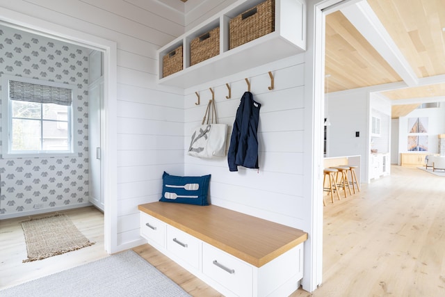 mudroom featuring wooden walls and light hardwood / wood-style floors