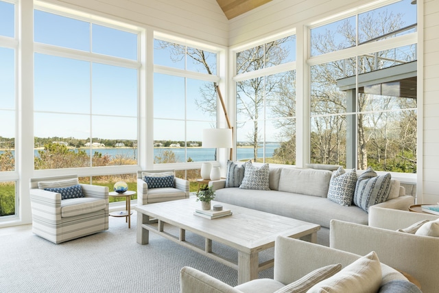 sunroom featuring a water view