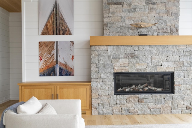 interior details featuring hardwood / wood-style flooring and wooden walls