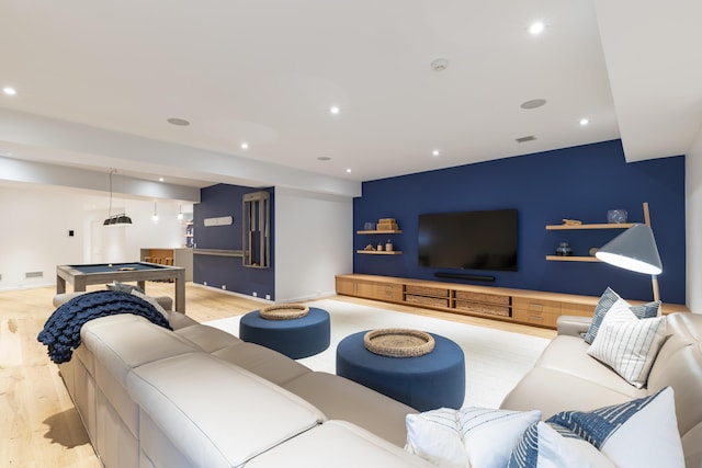 living room featuring billiards and light hardwood / wood-style floors