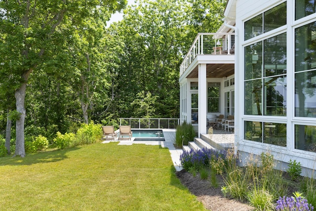 view of yard featuring a balcony