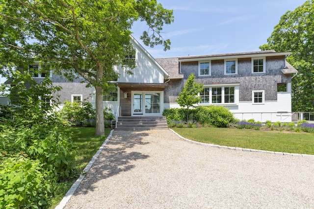 view of front facade with a front lawn and french doors