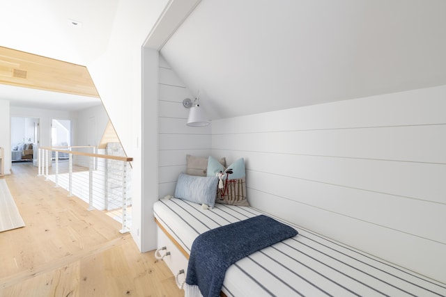 bedroom with hardwood / wood-style flooring and lofted ceiling