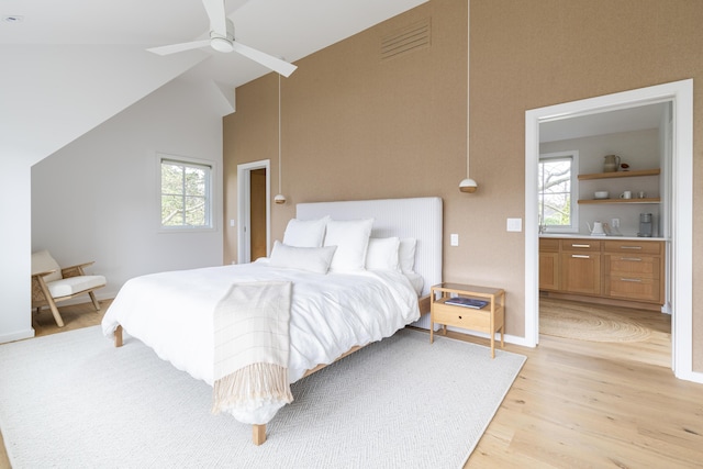 bedroom with light hardwood / wood-style floors, vaulted ceiling, and ceiling fan