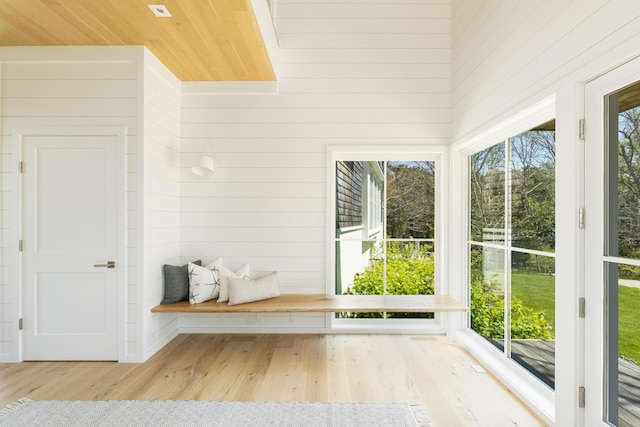 mudroom with a wealth of natural light, light hardwood / wood-style flooring, and wood ceiling