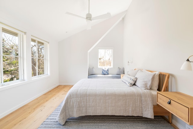 bedroom with hardwood / wood-style floors, vaulted ceiling, and ceiling fan