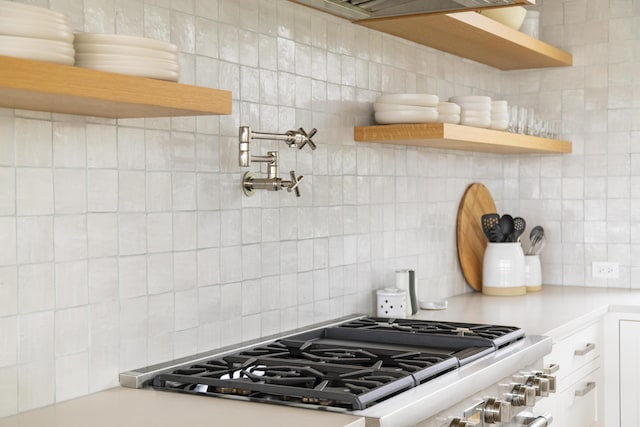 kitchen featuring white cabinetry and backsplash