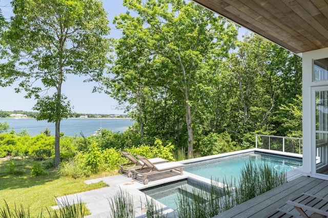 view of pool with a water view and a patio